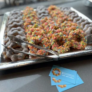 a tray of donuts with sprinkles