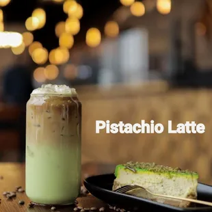 a glass of pistachio latte and a piece of cake