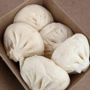 a close up of a box of dumplings