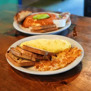 two plates of breakfast food on a table