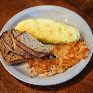 an omelet, toast, and hash browns