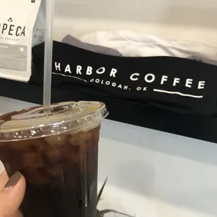 a hand holding a cup of coffee