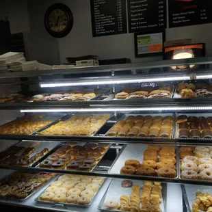 a variety of donuts in a display case