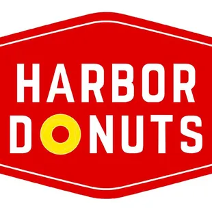 a red stop sign with the words harbor donuts
