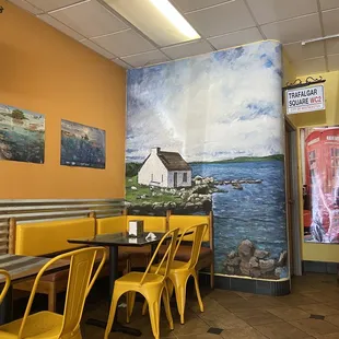 Dining area: what a pretty seaside mural and a London-esque theme going on~