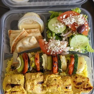 Chicken and vegetable kabob plate.