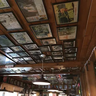 Walls and ceilings covered with framed photos.