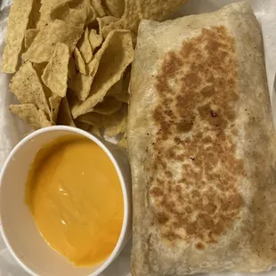 Burrito that was layered with beef, beans, lettuce, tomato, salsa and sour cream. Came with a side of chips and melted cheese.