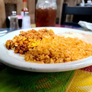 Huevos con chorizo, rice, and beans.