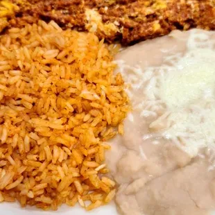 Huevos con chorizo, rice, and beans.