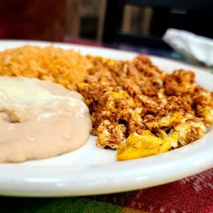 Huevos con chorizo, rice, and beans.