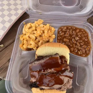 Beef brisket sandwich with Mac and cheese and bake beans.