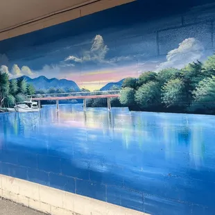 a mural of a boat on the water