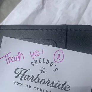 a handwritten sign on a wallet