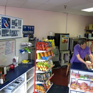 a woman preparing food in a store