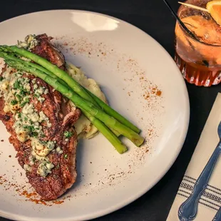 a steak and asparagus on a plate