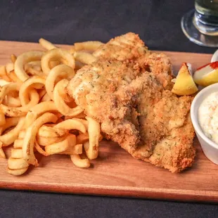 fish and chips on a wooden board