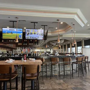 Huge wrap around bar with booths along windows and sides.