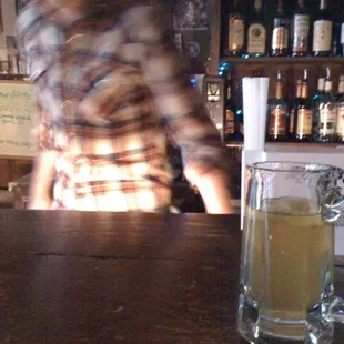 a blurry image of a man behind a bar