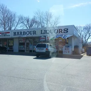 a car parked in front of a liquor store