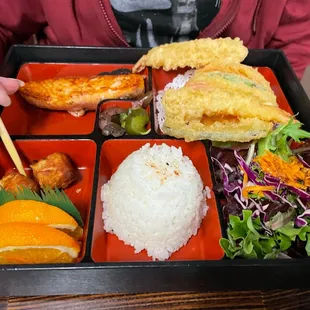 Two item bento with salmon and tempura.