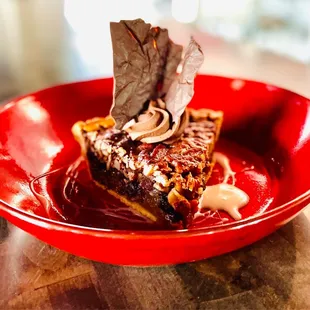 a piece of cake in a red bowl