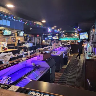 a bar with a row of bowling lanes