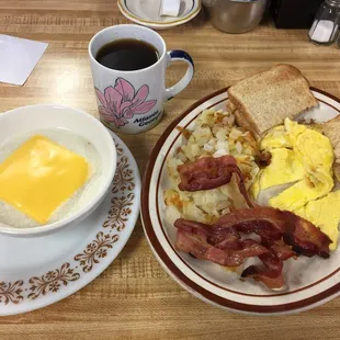 a breakfast of eggs, bacon, hash browns and coffee