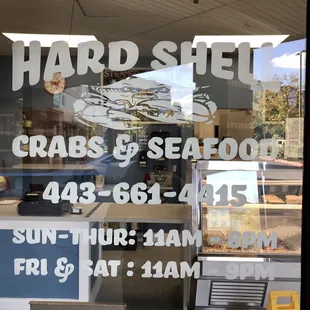 Front door with hours of operation.