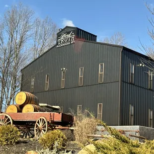 a black building with barrels on it