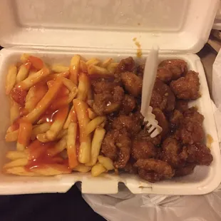 Honey garlic shrimp and French fries with bbq sauce drizzled on top