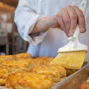 a person brushing a pastry with a brush