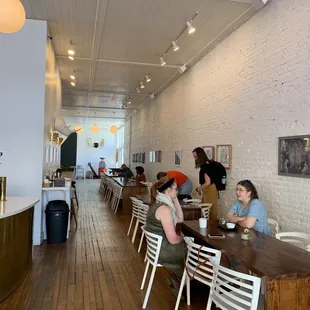 people sitting at tables in a coffee shop