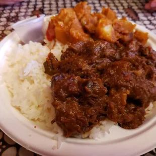 Rice plate with beef stew and sautéed potatoes in red pepper and coconut milk