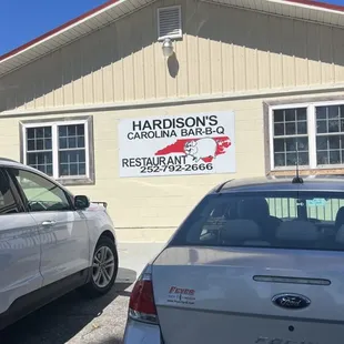 two cars parked in front of a restaurant