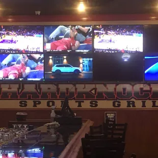 The end of the main huge bar with the first bank of TVs and logo in shot