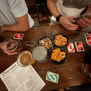 a table full of beer and snacks