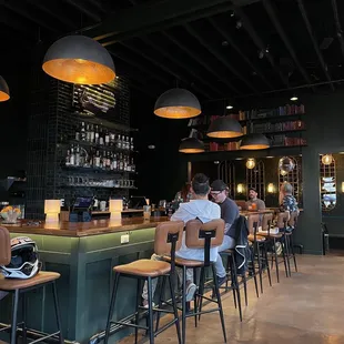 a group of people sitting at a bar
