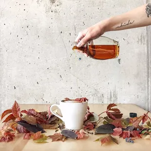 a person pouring tea into a cup