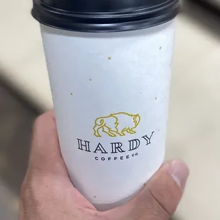 a hand holding a cup of coffee