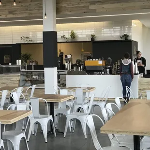 This location has a large coffee bar/sales counter, and if you peek behind post, you can see the glass display of fresh baked goods!