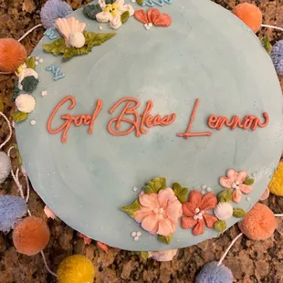 a cake decorated with flowers and words