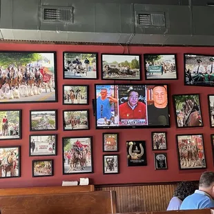 a wall full of framed photos