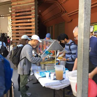 a man serving food to a group of people