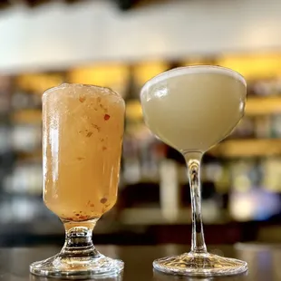 two cocktails on a bar