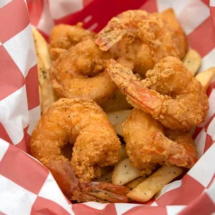 a basket of fried shrimp and fries