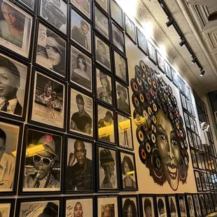 a wall full of black and white photos