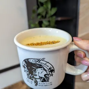 a person holding a cup of coffee