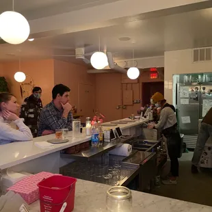 a group of people sitting at a counter