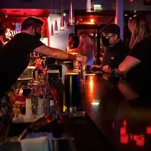 a man pouring a drink at a bar